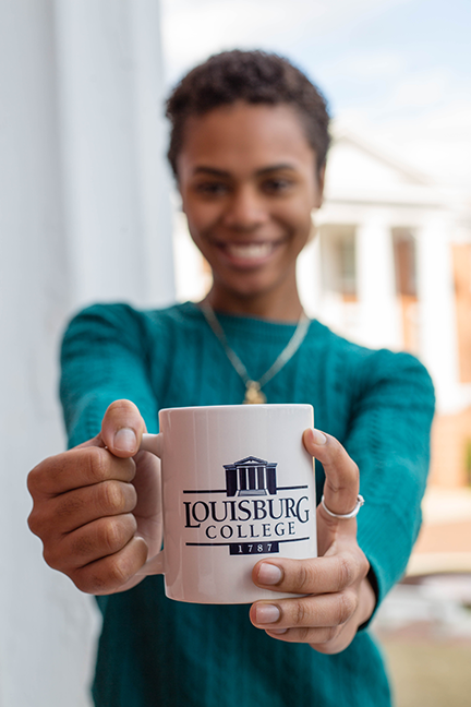 Student holding a Louisburg College mug