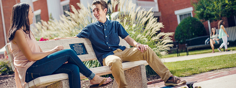 two students sitting on a bench